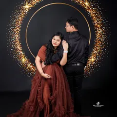 The rich, earthy tone of this brown ruffled gown is perfect for a glamorous yet grounded look, seen here in a romantic couple's portrait.