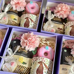 A close-up of my baby shower and first birthday return favors. This option includes a cute rabbit-themed mug, coffee concentrate, a custom cookie, and a donut soap.