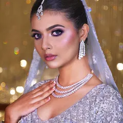 Another angle of this glamorous and modern bridal look. The cool-toned makeup and sparkling jewelry create an ethereal and enchanting vibe.