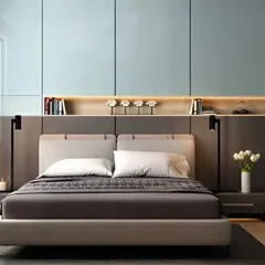 A modern bedroom featuring a full-wall headboard with built-in shelving and overhead storage cabinets. This custom furniture piece combines the bed, side tables, and storage into a single, cohesive unit.