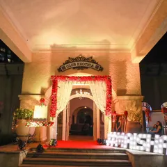 Make your event uniquely yours with personalized touches like a custom light-up hashtag. This grand entrance for a reception at Club Exotica features a classic red carpet and a beautiful floral archway, making the couple's hashtag a central feature.
