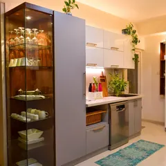 This angle showcases the glass crockery unit and the integrated dishwasher. It’s all about seamless design and functionality.