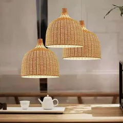 This set of three classic dome-shaped pendant lights, woven from natural rattan, provides a warm, downward glow perfect for suspension over a dining table or kitchen island. Their timeless design complements a wide range of interior styles.