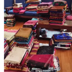 This is what the decluttering stage of a new home setup looks like. We lay out all the sarees to categorize them by weave, color, and occasion before organizing the closet.