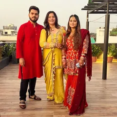 A family celebrating together. The client on the right wears the burnt orange gharara set, while her mother wears a custom mustard sharara, also with dabka hand embroidery.