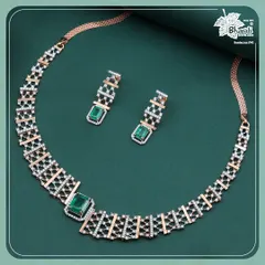 Our Emerald Zarnaya set embodies modern royalty. This 18ct rose gold necklace and earring suite features a geometric lattice of brilliant diamonds, punctuated by the deep, regal green of emeralds for a truly contemporary statement.