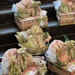 A collection of beautiful wedding invitation hampers, designed in a delicate pink and gold theme. Each hamper is thoughtfully arranged in ornate trays, ready to be sent to loved ones.