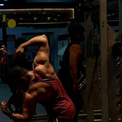 A defined and muscular back is built with heavy rows and pull-ups. This pose showcases the "Christmas tree" lower back, a sign of low body fat and a well-developed back.