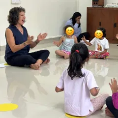 Our training is led by UK-based expert Naheed Shimala. This image captures a moment of joyful interaction in one of her sessions, demonstrating how she connects with young learners through expressive singing and hand gestures to teach musical concepts.