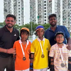 Our coaching team with a group of young male champions. We are proud to guide athletes of all ages and genders to success in competitive roller sports.