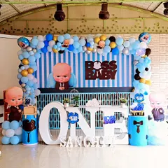 A classic Boss Baby themed first birthday party setup. This package includes a striped backdrop, character cutouts, themed pedestals, and a large "ONE" table, ensuring every detail is perfectly coordinated for your little boss.