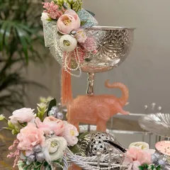 A luxurious silver-themed hamper designed for Diwali. The intricately designed bowl and elephant figurine, paired with soft pastel flowers, create a gift that feels both royal and thoughtful.