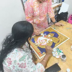 Here I am providing one on one guidance during a Tanjore painting session. Our small batch sizes ensure every student gets personalized attention to help them navigate intricate techniques and bring their artistic vision to life.