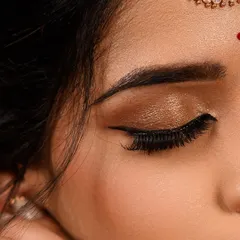 A detailed shot of a bronze smokey eye with a sharp winged liner. This is a versatile look that adds drama and definition, perfect for an evening event or a bold photoshoot.