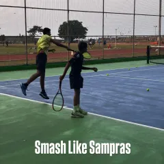 A powerful smash requires timing, technique, and confidence. Here, a coach guides a young player to execute a perfect overhead smash, a crucial skill for any aspiring champion.