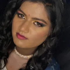 A direct look at the camera, showcasing the full impact of the colorful and festive eye makeup.