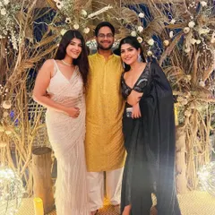 The hosts and guests posing in front of our custom boho backdrop. The installation, made of dried pampas grass, branches, and delicate white florals, created the perfect photo opportunity for the Diwali party.