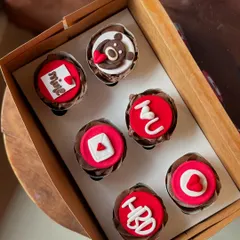 A box of six chocolate cupcakes with assorted red and white fondant toppers. These are perfect for Valentine's Day, an anniversary, or just to send a little love.