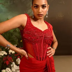 The corset blouse of the Stardust Saree Set is a masterpiece of beadwork. The structured boning is entirely covered in hand-sewn red beads, creating a texture that is rich and luxurious.