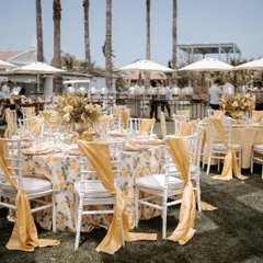 An outdoor luncheon in Antalya with a vibrant yellow theme. The floral tablecloths and matching chair sashes brought a sunny and cheerful elegance to the celebration.