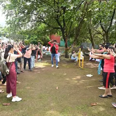 Leading a group warm-up exercise during an outdoor corporate event. I start my team-building sessions by getting everyone synchronized and energized, setting a positive and collaborative tone for the day.