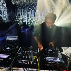 Bringing happiness through sound. This shot captures me at my console under the stage lights, focused on delivering a perfect mix for the crowd.