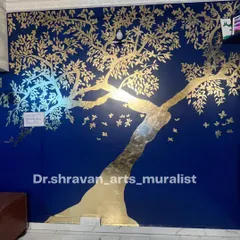 The "Tree of Life" is a classic and powerful symbol. In this mural, I used gold foil on a deep blue wall to create a stunning silhouette that shimmers and seems to glow, especially when the light hits it.