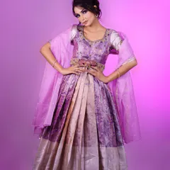 A model in a unique lavender gown made from silk saree fabric. This is a great example of how we can create modern silhouettes from traditional materials.