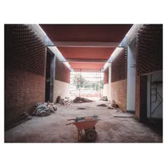The raw, unfinished interior of the memorial's main hall. The exposed brickwork and concrete beams show the fundamental structure before the final finishes are applied.