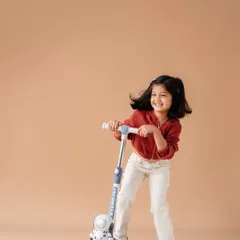 My daughter enjoying her scooter during our family photoshoot. Capturing her playful spirit and joy is something I'll always treasure.