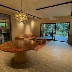 For this office, we designed a relaxed and modern environment where the indoor ambiance aligns with the natural surroundings. The open-plan waiting area features comfortable seating, earthy tones, and a glass partition leading to the main workspace. A large sliding door opens to a green patio, creating a perfect setting for a stress-free and inspiring workday.
