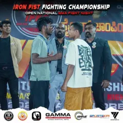 The pre-fight face-off is an intense mental battle. Here, I'm watching my student, Dhanush, stare down his opponent before the Iron Fist Fighting Championship, ready to execute our game plan.