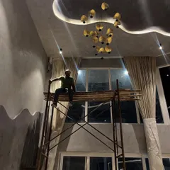 Why have a flat white ceiling when you can have this? We designed this custom ceiling with organic curves and dramatic backlighting, complemented by a sculptural chandelier, to draw the eye upward and create a sense of grandeur.