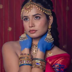 A close-up of the model, showing how the hairstyle is complemented by traditional jewellery and makeup.