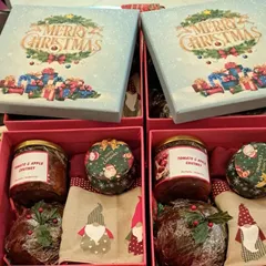 Two Christmas hampers side-by-side, showing the beautiful "Merry Christmas" gift box lid. These are perfect for corporate gifting or for sending to multiple family members.