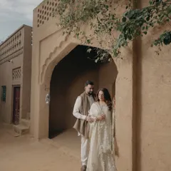 An intimate embrace in the alleyway of a Punjabi village. The natural light and rustic architecture provide a warm and authentic setting for this romantic couple portrait.