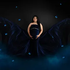 A touch of fantasy for this maternity portrait. The rich blue velvet gown is styled to look like butterfly wings, creating a magical and ethereal image for the mom-to-be.
