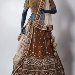 Why buy when you can rent? This elegant brown bridal lehenga with a fully embroidered gold blouse is a unique and sophisticated option for your big day.