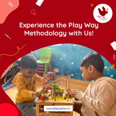 Two boys work together on a colorful bead maze, demonstrating our Play Way Methodology in action. Through play, children naturally develop critical thinking, social skills, and emotional expression.