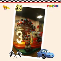 Welcome to the races. This Disney's Cars themed party featured a custom backdrop with a light-up number '3' and a balloon arch designed to look like a finish line.