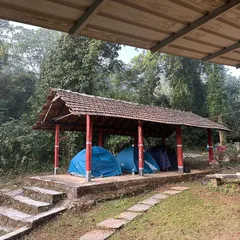 Tents pitched under a traditional tiled roof shelter in Agumbe. We provide a rustic yet secure camping experience, close to nature.