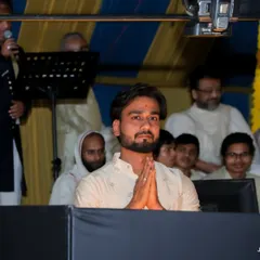 A moment of prayer and respect before my performance at Mahudi Tirth. The spiritual energy of such events is profoundly moving.