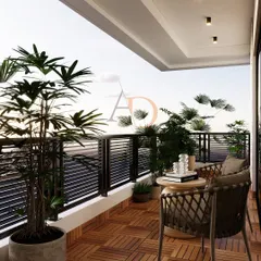A wider view of the balcony, showing the seating arrangement and the seamless connection to the indoors through large sliding glass doors.