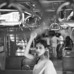 This shot captures the feeling of being in the crowd, yet lost in your own world. The motion blur of other passengers highlights the subject's stillness.