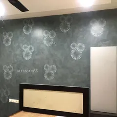 This bedroom accent wall features a modern, repeating circular pattern in silver over a dark grey textured finish. It's a great way to add a contemporary design element to a room without overwhelming the space.