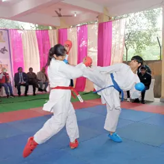 Real training is about applying your skills. Here, two of my students are engaged in a kumite (sparring) session during a championship. This is where technique, speed, and fighting spirit are tested on the mat.