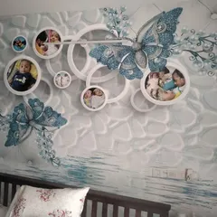A custom 3D wallpaper featuring a large blue butterfly and photo frames, designed to incorporate personal family pictures directly into the wall art.
