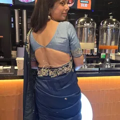 A back view of our deep blue saree, showcasing the stylish and modern blouse design.