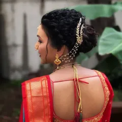 A close-up of the intricate hairstyle for our Maharashtrian bride. The braided bun is adorned with traditional accessories for a complete look.