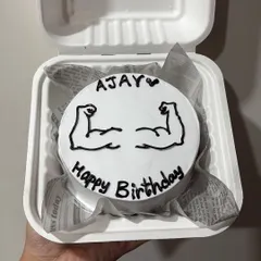 A birthday bento cake for a fitness lover, complete with hand-drawn biceps. A great way to personalize a cake based on someone's hobbies.